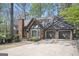 A view of the right side of the home with a large driveway leading to a three car garage at 2689 Spring Rock Ne Ct, Roswell, GA 30075