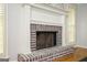 Living room brick fireplace with white mantel, hearth, and wood flooring at 2689 Spring Rock Ne Ct, Roswell, GA 30075