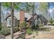 Beautiful brick home with a large chimney, bay windows, and mature trees surrounding the property at 2689 Spring Rock Ne Ct, Roswell, GA 30075