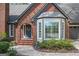 Charming brick home featuring a well-manicured lawn, bay windows, and an arched entryway at 2689 Spring Rock Ne Ct, Roswell, GA 30075