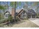 Charming brick home featuring a well-manicured lawn, bay windows, and an attached two car garage at 2689 Spring Rock Ne Ct, Roswell, GA 30075