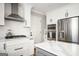 Contemporary kitchen with white cabinetry, modern appliances, and hardwood floors at 2689 Spring Rock Ne Ct, Roswell, GA 30075