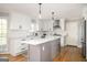 Well-lit kitchen with white cabinets, stainless steel appliances, and an island at 2689 Spring Rock Ne Ct, Roswell, GA 30075