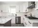 Bright kitchen featuring white cabinetry, stainless steel appliances, and an island at 2689 Spring Rock Ne Ct, Roswell, GA 30075