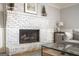Living room showcasing a white brick fireplace with hearth and mantle at 2689 Spring Rock Ne Ct, Roswell, GA 30075