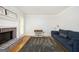 Comfortable living room featuring a fireplace, a large rug, a blue couch and natural light at 2689 Spring Rock Ne Ct, Roswell, GA 30075