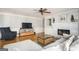 Cozy living room with fireplace, hardwood floors, and large television at 2689 Spring Rock Ne Ct, Roswell, GA 30075