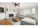Bright living room with fireplace, ceiling fan, hardwood floors and lots of natural light at 2689 Spring Rock Ne Ct, Roswell, GA 30075