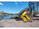 Playground area beside a calm lake featuring slides and other play equipment at 2689 Spring Rock Ne Ct, Roswell, GA 30075