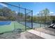 Community tennis courts with new blue and green surfaces surrounded by trees at 2689 Spring Rock Ne Ct, Roswell, GA 30075