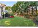 Spacious backyard with lush lawn, playset, and treelined back property line at 2740 Greymont Ct, Cumming, GA 30041