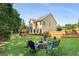 Spacious backyard with lush green grass, playground, firepit, and mature trees at 2740 Greymont Ct, Cumming, GA 30041