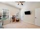 Bright bedroom with a ceiling fan, large window, and wall-mounted television at 2740 Greymont Ct, Cumming, GA 30041