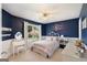 Charming bedroom with blue accent wall, chair rail, and white furniture at 2740 Greymont Ct, Cumming, GA 30041