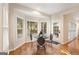 Breakfast nook featuring windows for natural light, a view to the backyard, and hardwood floors at 2740 Greymont Ct, Cumming, GA 30041