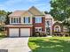 Beautiful two-story home with brick and siding, well-kept lawn, and attached two-car garage at 2740 Greymont Ct, Cumming, GA 30041