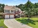 Stately two-story home featuring a brick facade, manicured landscaping, and a spacious driveway leading to a two-car garage at 2740 Greymont Ct, Cumming, GA 30041