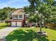 Beautiful two-story home featuring a brick facade, manicured landscaping, and a spacious driveway leading to a two-car garage at 2740 Greymont Ct, Cumming, GA 30041