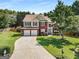 Inviting two-story home featuring a brick facade, manicured landscaping, and a spacious driveway leading to a two-car garage at 2740 Greymont Ct, Cumming, GA 30041