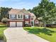 Charming two-story brick home with manicured lawn and two-car garage, inviting curb appeal at 2740 Greymont Ct, Cumming, GA 30041