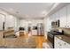 Bright kitchen with granite countertops, stainless appliances, white cabinets, and hardwood floors at 2740 Greymont Ct, Cumming, GA 30041