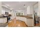 Bright kitchen features stainless appliances, hardwood floors, white cabinets, and granite countertops at 2740 Greymont Ct, Cumming, GA 30041