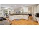 Open kitchen features white cabinetry, granite countertops, stainless appliances, and a sunlit breakfast nook at 2740 Greymont Ct, Cumming, GA 30041