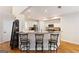 Kitchen with breakfast bar, stainless appliances, granite counters, white cabinets, and hardwood floors at 2740 Greymont Ct, Cumming, GA 30041
