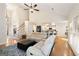 Spacious living room with hardwood floors, a ceiling fan, and an open layout into the kitchen at 2740 Greymont Ct, Cumming, GA 30041