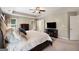 A primary bedroom with a tray ceiling, ceiling fan, and an open en suite bath at 2740 Greymont Ct, Cumming, GA 30041