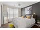 Cozy bedroom features a large bed, buffalo wall art, neutral walls, and a ceiling fan at 4113 Ashford Green Dr, Duluth, GA 30096