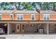 Brick townhome featuring a covered parking area and a front door with sidelight windows at 4113 Ashford Green Dr, Duluth, GA 30096