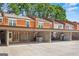 Brick townhome featuring a covered parking area and a front door with sidelight windows at 4113 Ashford Green Dr, Duluth, GA 30096