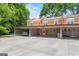 Brick townhome featuring a covered parking area and a front door with sidelight windows at 4113 Ashford Green Dr, Duluth, GA 30096