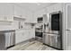 The modern kitchen features white cabinets, stainless appliances, and beautiful flooring at 4113 Ashford Green Dr, Duluth, GA 30096