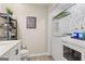 A well lit laundry room featuring a front loading washer and dryer set and open shelving at 4113 Ashford Green Dr, Duluth, GA 30096