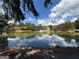The pond in the community with fountain and reflections of the cloudy sky at 4113 Ashford Green Dr, Duluth, GA 30096