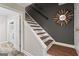 Interior staircase featuring hardwood treads, white risers, and a decorative mirror at 4113 Ashford Green Dr, Duluth, GA 30096