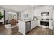 Bright open-concept living space features modern kitchen with stainless appliances and adjacent cozy living area at 2810 Georgia Aster Nw Way # 6, Atlanta, GA 30318