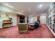 Carpeted basement boasting a brick fireplace, built-in bookshelves, and plenty of room for entertaining at 3030 Spalding Dr, Sandy Springs, GA 30350