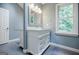 Bright bathroom featuring a double vanity with storage and a large window at 3030 Spalding Dr, Sandy Springs, GA 30350