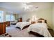 Bedroom featuring two beds, neutral walls, and a ceiling fan at 3030 Spalding Dr, Sandy Springs, GA 30350