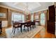 Formal dining room with hardwood floors, chandelier, and bay window at 3030 Spalding Dr, Sandy Springs, GA 30350