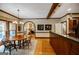 Welcoming dining area with hardwood floors, wood table, chandelier, and connection to the kitchen at 3030 Spalding Dr, Sandy Springs, GA 30350