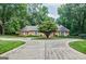 Well-maintained brick home with circular driveway and mature landscaping at 3030 Spalding Dr, Sandy Springs, GA 30350