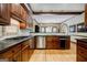 Stylish kitchen with wood cabinets, granite countertops, stainless steel appliances, and hardwood floors at 3030 Spalding Dr, Sandy Springs, GA 30350