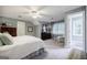 Comfortable bedroom with neutral walls, a ceiling fan, and a sitting area at 3030 Spalding Dr, Sandy Springs, GA 30350