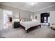 Spacious main bedroom with a four-poster bed, neutral colors, and access to a private sitting area at 3030 Spalding Dr, Sandy Springs, GA 30350