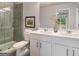 Modern bathroom with double sinks, white cabinets, and tiled walk-in shower at 5615 Hislop Ln # 82, Mableton, GA 30126