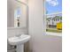Bathroom featuring modern pedestal sink and window at 5615 Hislop Ln # 82, Mableton, GA 30126
